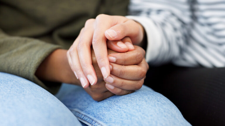Holding hands, support and closeup of a couple in therapy for love, respect or trust in marriage